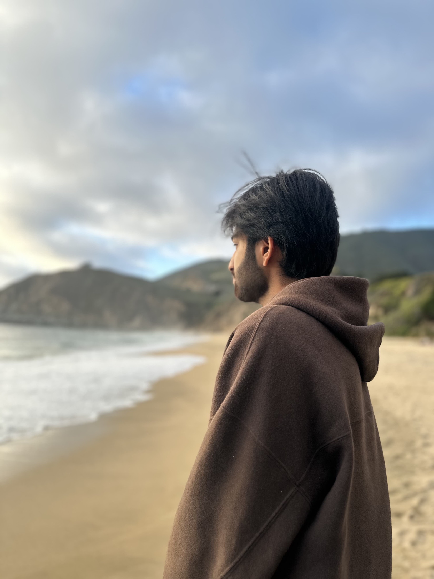 Kartikeya looking at the ocean from a beach