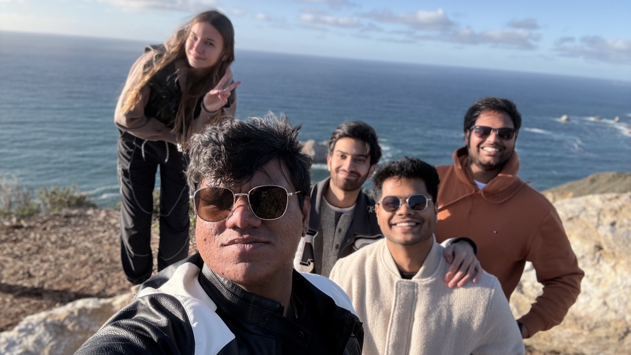 Group selfie near a coastal cliff