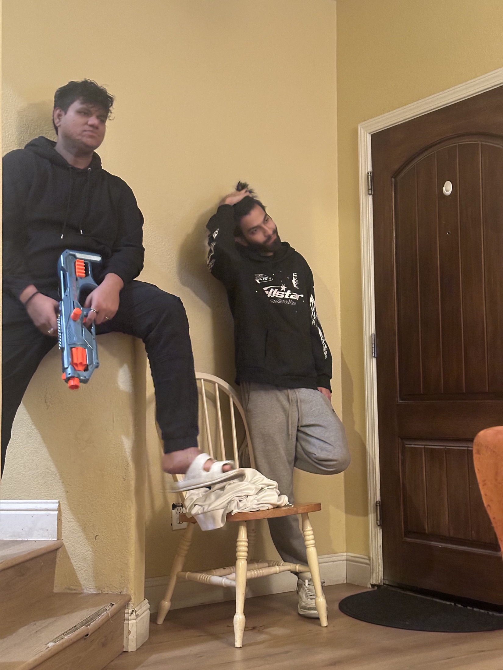 Kartikeya standing on a chair indoors