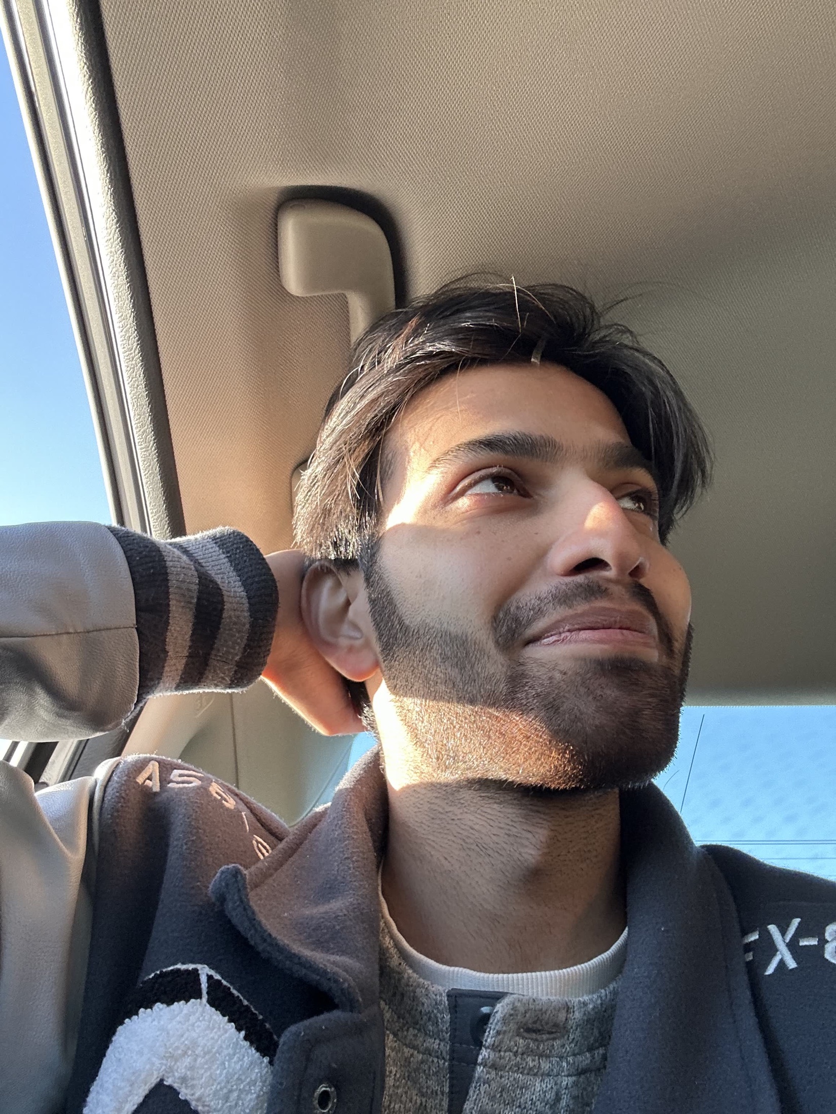 Kartikeya looking out of a car window